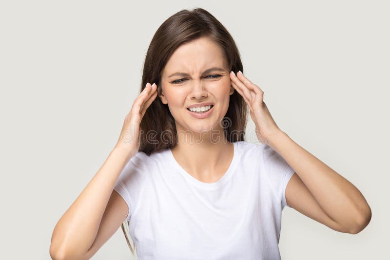 Millennial woman touching temples suffers from migraine studio shot stock photos Millennial woman touching temples suffers from migraine studio shot stock photos