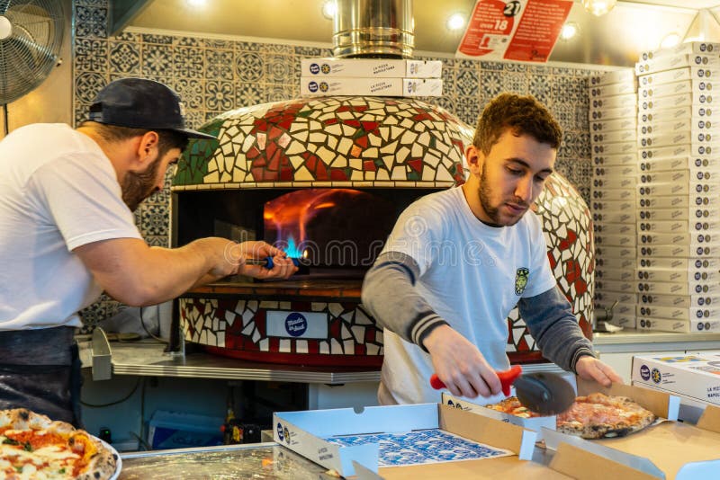 Milton Keynes,December 21,2018.Two People Cooking Pizza Editorial Stock