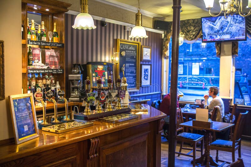CAMBRIDGE, UK - JANUARY 18, 2015: Miltre tavern, Classic english public house interior. Beer counter. CAMBRIDGE, UK - JANUARY 18, 2015: Miltre tavern, Classic english public house interior. Beer counter