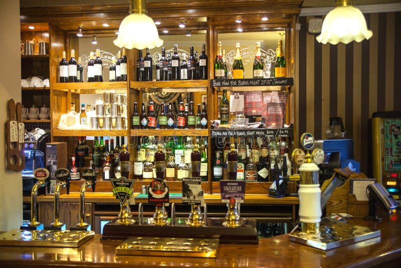CAMBRIDGE, UK - JANUARY 18, 2015: Miltre tavern, Classic english public house interior. Beer counter. CAMBRIDGE, UK - JANUARY 18, 2015: Miltre tavern, Classic english public house interior. Beer counter