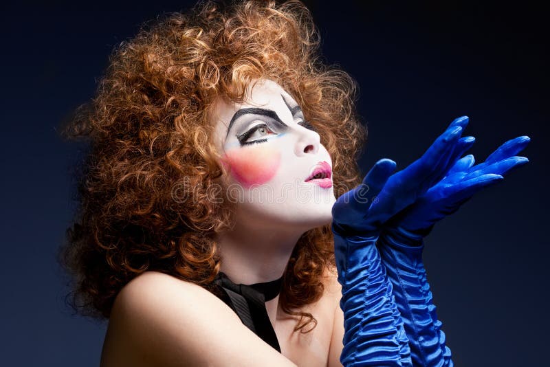 Woman mime with theatrical makeup. Studio shot. Woman mime with theatrical makeup. Studio shot.