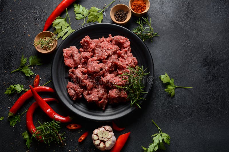 Minced Beef. Ground Meat with Ingredients for Cooking on Black