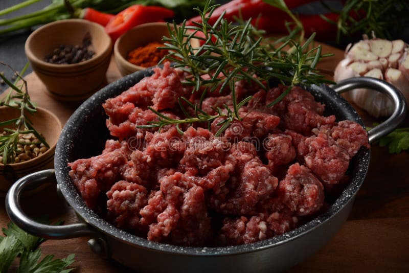 Minced Beef. Ground Meat with Ingredients for Cooking on Black