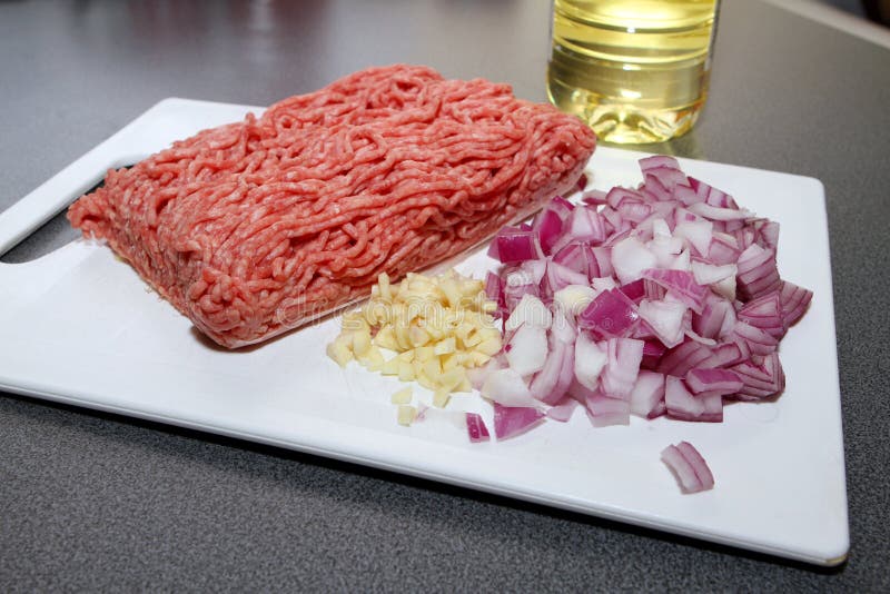 Minced Meat (ground Beef) with Onion, Garlic and Oil on Chopping Board