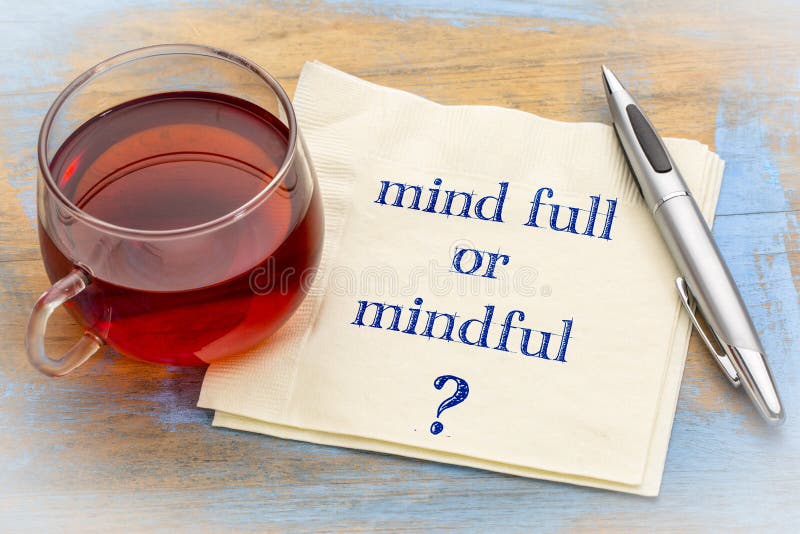 Mind full or mindful ? Inspiraitonal handwriting on a napkin with a cup of tea. Mind full or mindful ? Inspiraitonal handwriting on a napkin with a cup of tea.