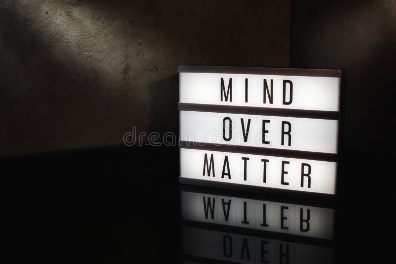 Mind over matter motivational message on a light box in a cinematic moody background