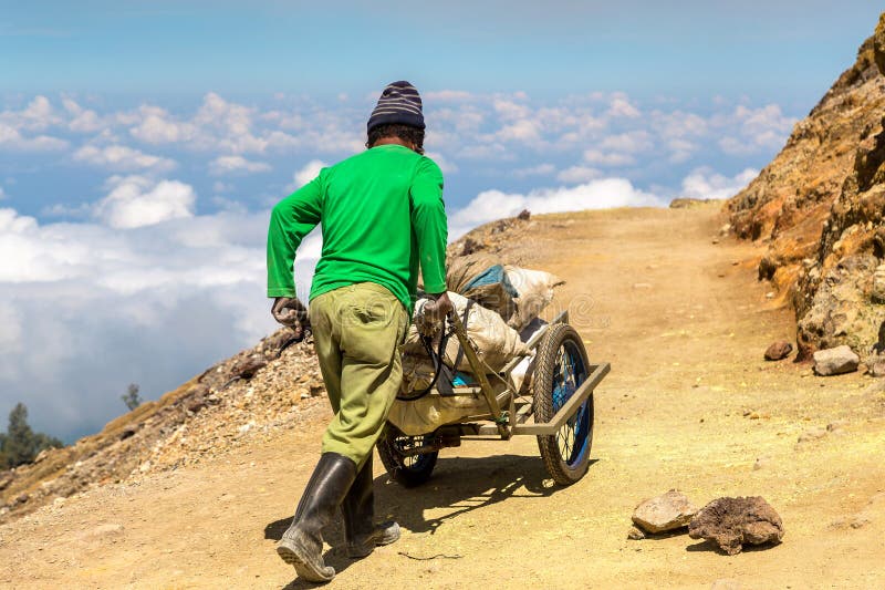 Miner inside volcano Ijen royalty free stock photos