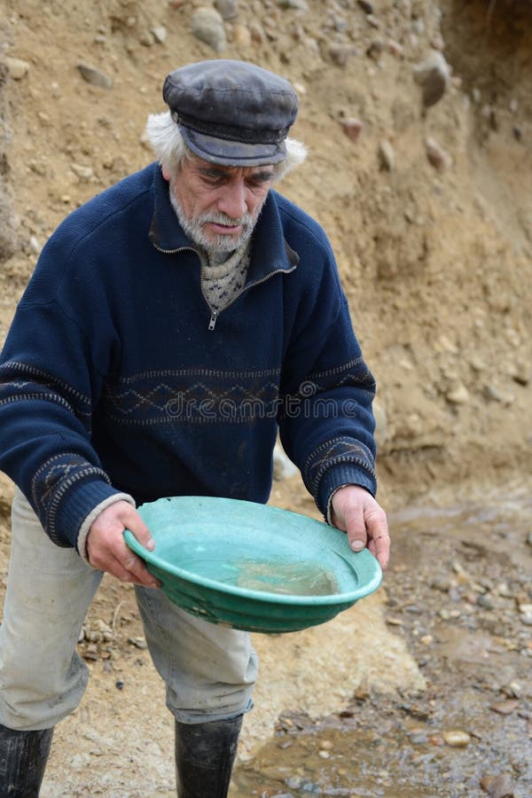 Gold Digger Shows Tourists Alluvial Gold Sand Mined In The Mine On