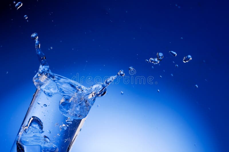 Mineral water splashing out from glass stock photos