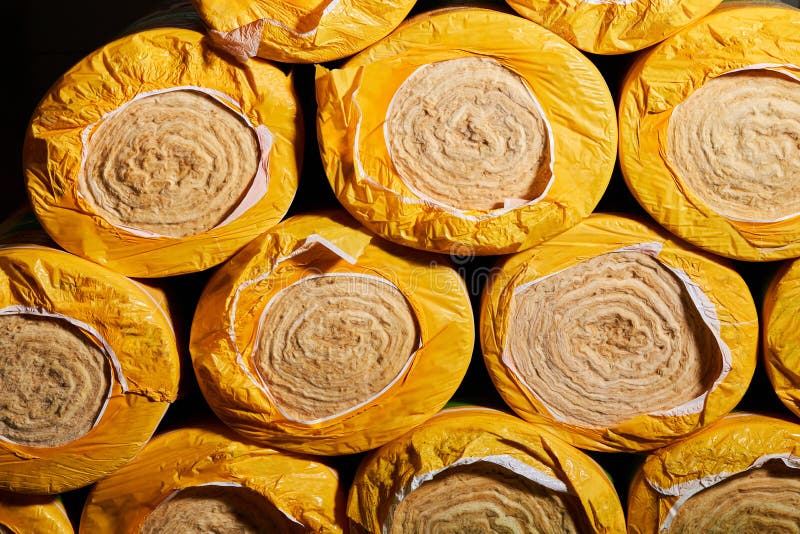 Mineral Wool Insulation Rolls in Yellow Packaging Close Up. Stock Photo
