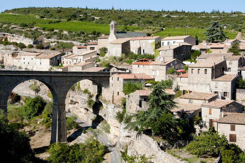 The Town of Minerve on the Edge of a Cliff with a Bridge Stock Image