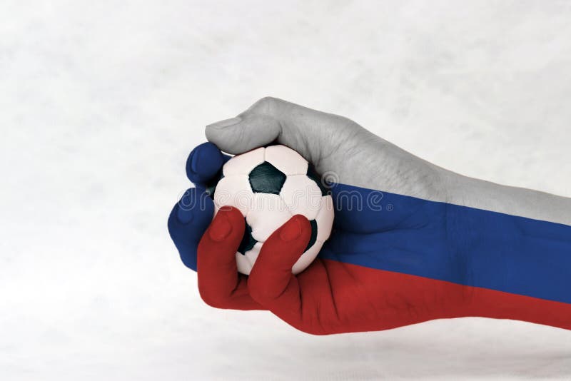 Mini ball of football in Russia flag painted hand on white background. Concept of sport or the game in handle or minor matter. stock images Mini ball of football in Russia flag painted hand on white background. Concept of sport or the game in handle or minor matter. stock images