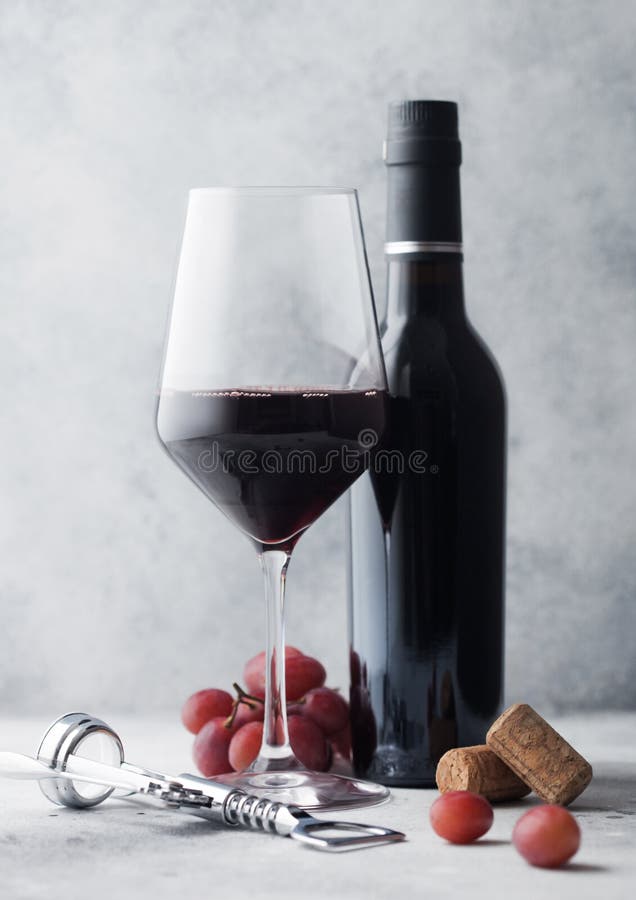 Luxury Mini Bottles of Red Wine and Empty Glasses with Dark Grapes with