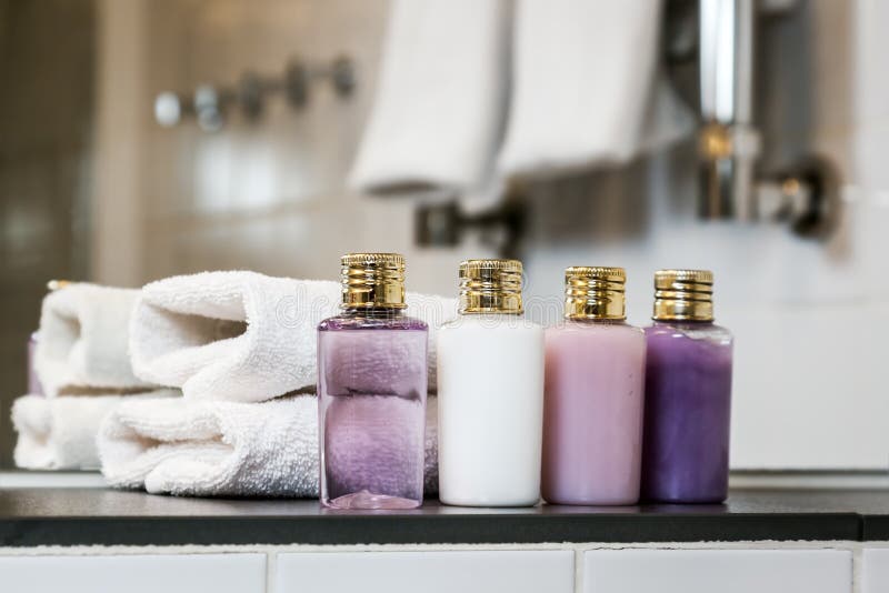 Mini bottles of cosmetics and towels on the table