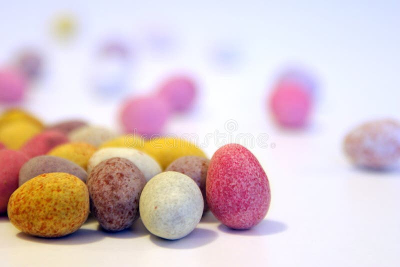 Mini candy chocolate eggs on a white surface