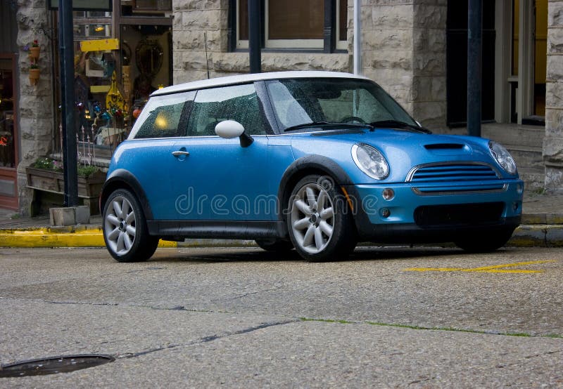 2008 blue Mini Cooper two door sedan parked on an incline in Eureka Springs, Arkansas. 2008 blue Mini Cooper two door sedan parked on an incline in Eureka Springs, Arkansas.