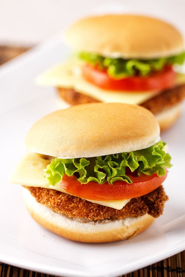 Mini Crispy Chicken Burger with Lettuce Tomato and Cheese. Stock Photo