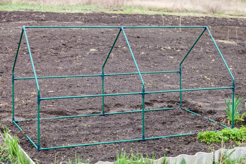 Frame collapsible mini greenhouses installed in the vegetable garden. Frame collapsible mini greenhouses installed in the vegetable garden