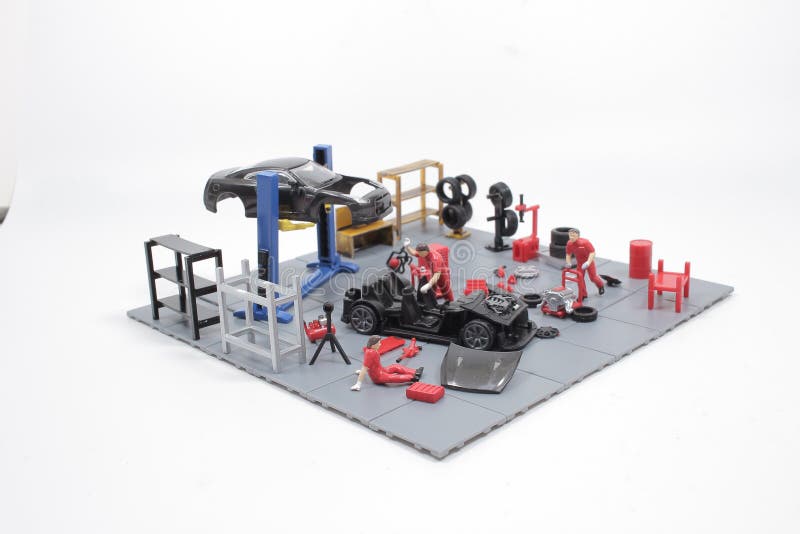 A Mini Mechanics Repairing Toy Car,concept of the Stock Photo