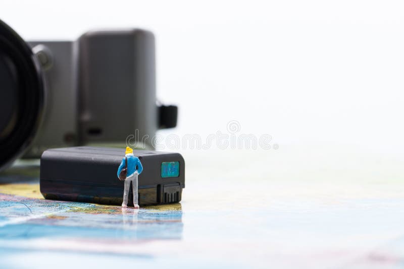 Mini people model checking digital camera for travel stock image Mini people model checking digital camera for travel stock image