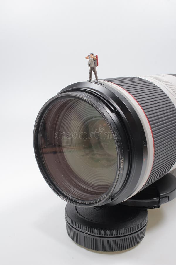A Mini Photographer Standing on a Camera Lens Stock Photo Image of