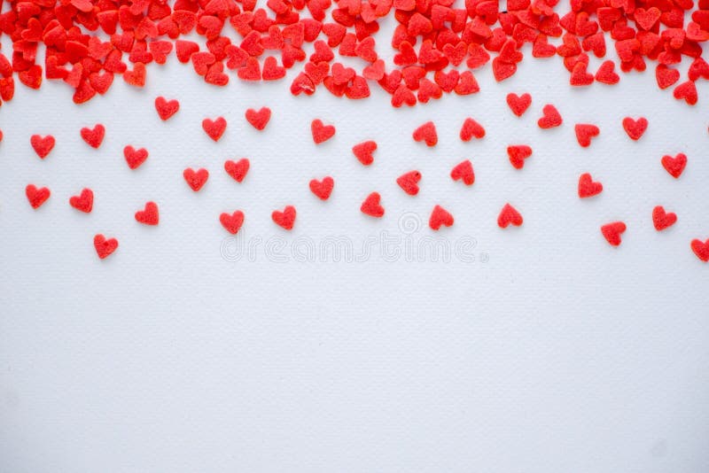 Mini red hearts candy on white background, concept love card, concept Valentine, Valentine`s day, a heart shape is symbol of love, select focus