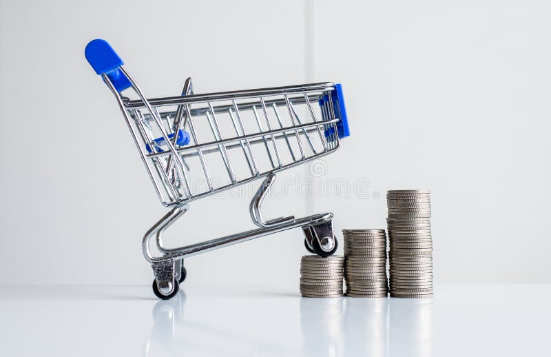 Mini shopping cart with step of coins stacks,Finance and money shopping concept royalty free stock images