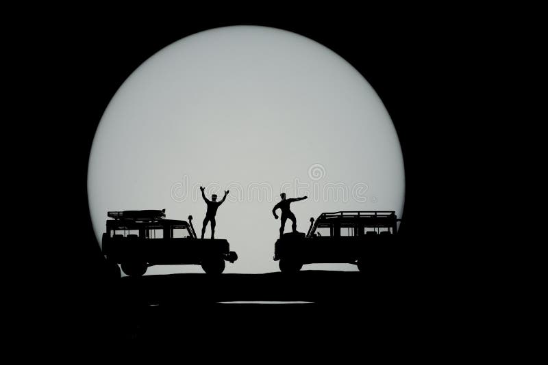 Miniature toys of two men celebrate triumphantly at the mountain concept with full moon in the background. Miniature toys of two men celebrate triumphantly at the mountain concept with full moon in the background.