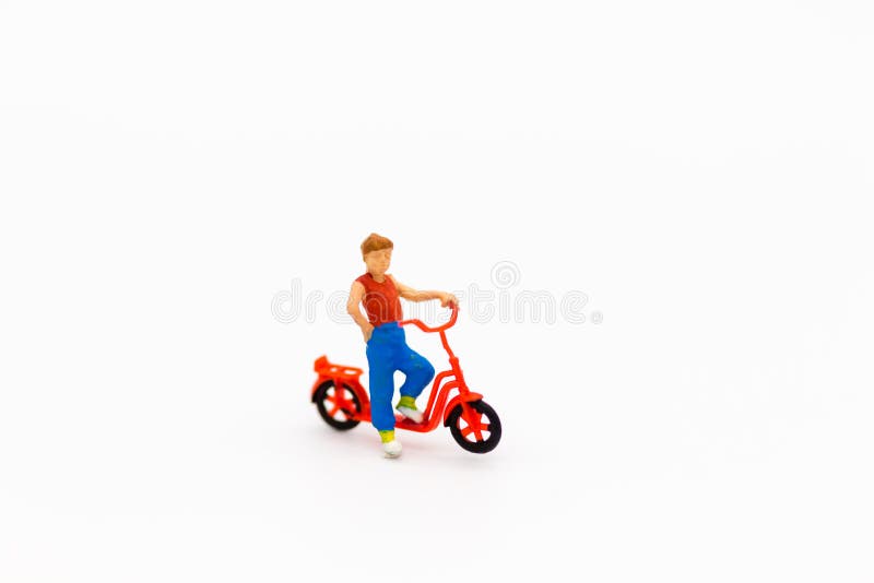 Miniature children: Boy playing with bicycle. Image use for child physical Development