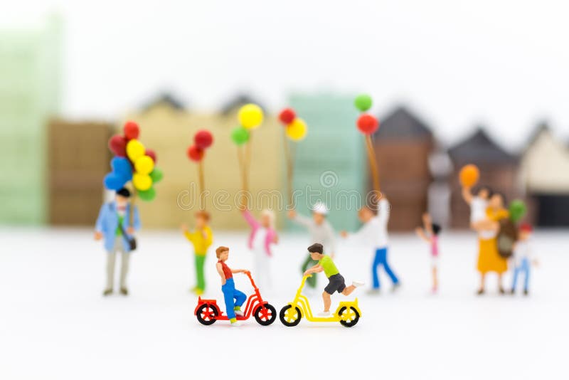 Miniature children: Boys cycling play fun in the playground. Image use for Children`s day