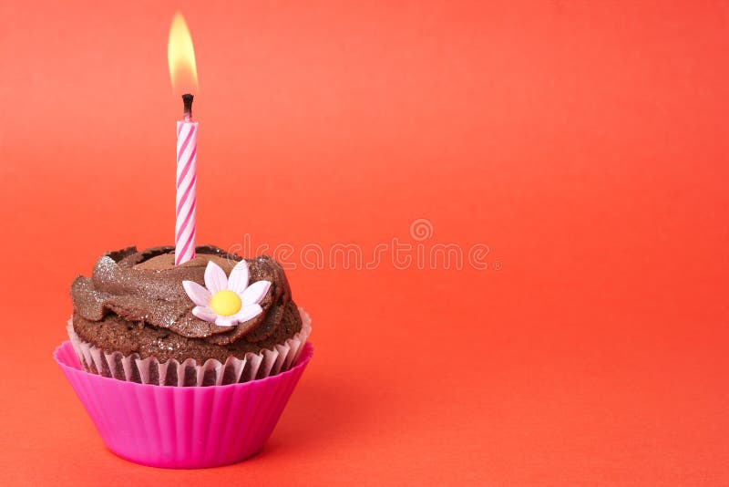 Miniature chocolate cupcake with candle