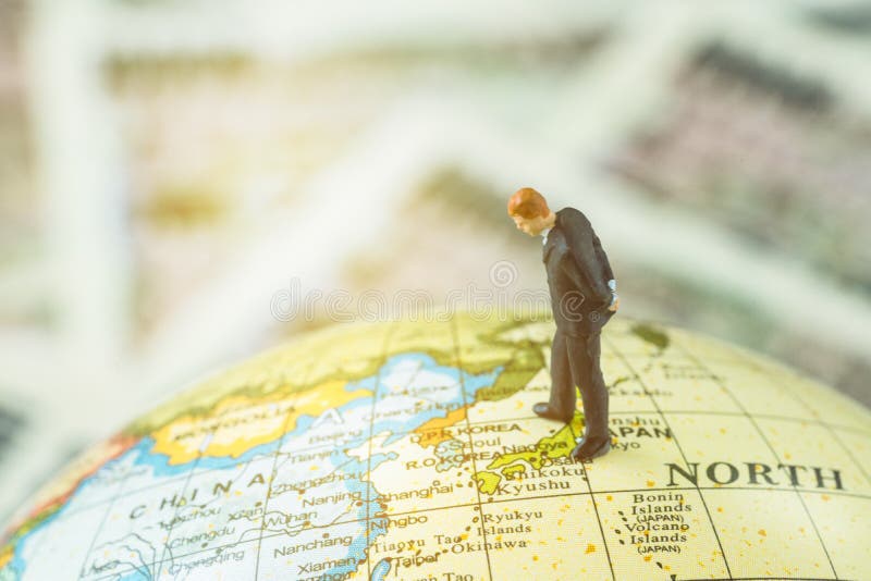 Miniature figure country leader man standing and looking at north korea map on globe as world critical nuclear missile war stock images Miniature figure country leader man standing and looking at north korea map on globe as world critical nuclear missile war stock images