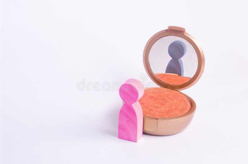 A miniature figure of a man looks in the mirror and sees his hatching in another gender. The concept of gender identity. Transgender, gay lesbian person. Sex royalty free stock images A miniature figure of a man looks in the mirror and sees his hatching in another gender. The concept of gender identity. Transgender, gay lesbian person. Sex royalty free stock images