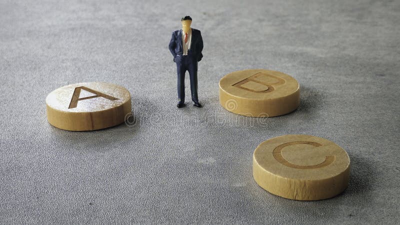 Miniature Figurine in Suit Standing Near Alphabet Blocks "ABC. Alphabet project stock images, royalty-free photos and pictures