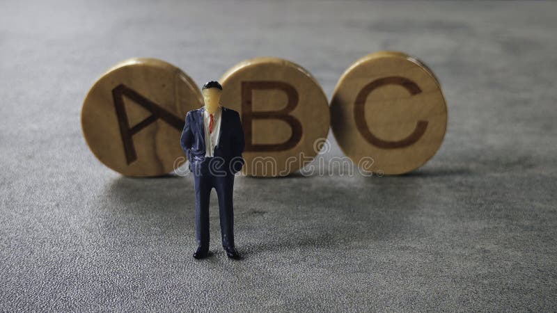 Miniature Figurine in Suit Standing Near Alphabet Blocks "ABC. Alphabet project stock images, royalty-free photos and pictures