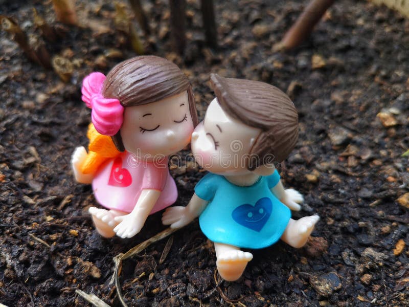 Miniature of kissing babies with grasses background. royalty free stock photos Miniature of kissing babies with grasses background. royalty free stock photos