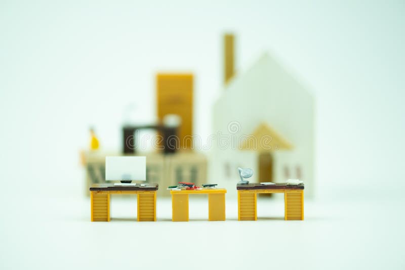 Miniature office table with blur of wood home background