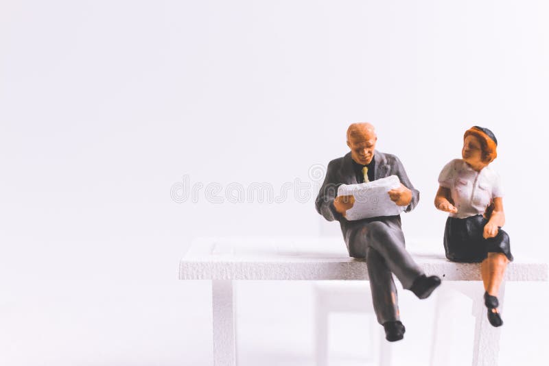 Miniature people business concept sitting on chair with a space royalty free stock images Miniature people business concept sitting on chair with a space royalty free stock images