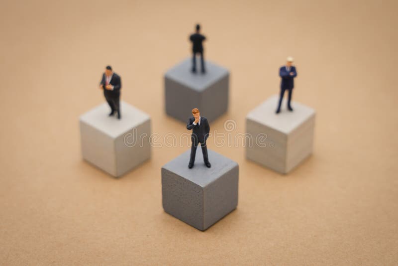 Miniature 4 people businessmen standing on Wooden cube Investment Analysis Or investment Blockchain concept. as background