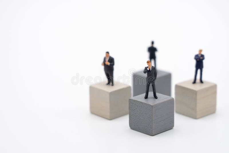 Miniature 4 people businessmen standing on Wooden cube Investment Analysis Or investment Blockchain concept. as background
