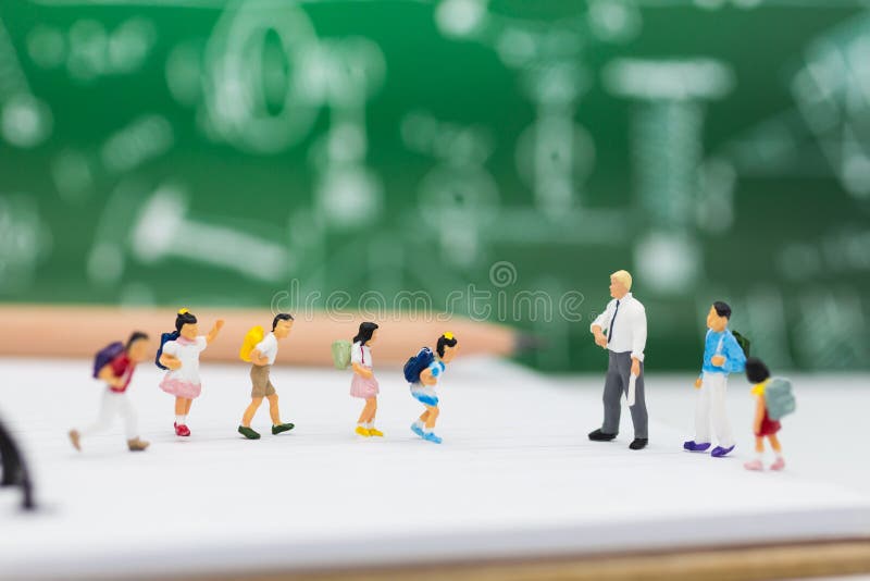 Miniature people : children studying with teacher. Image use for back to school concept. stock photography Miniature people : children studying with teacher. Image use for back to school concept. stock photography