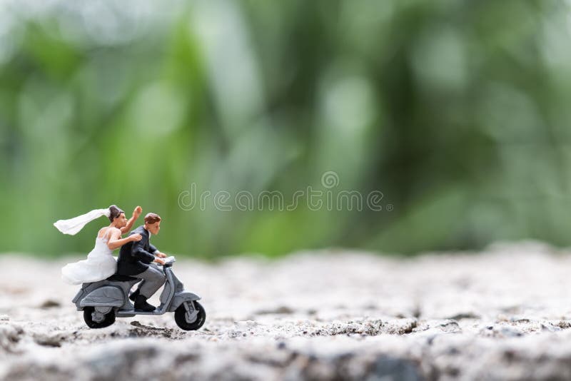 Miniature people : Couple riding the motorcycle   , Valentine`s Day concept