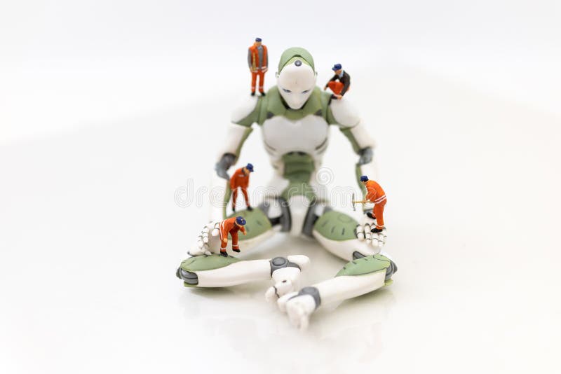 Miniature people : Engineering is developing an AI robot system, using labor instead of people. Image use for new technology in royalty free stock images Miniature people : Engineering is developing an AI robot system, using labor instead of people. Image use for new technology in royalty free stock images