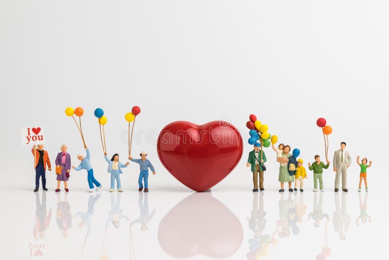 Miniature people happy love family holding balloons with red hea