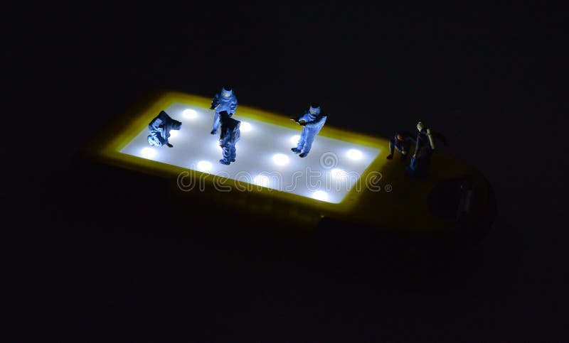 Miniature people in hazmat suits are working with black background. Working concept of miniature people royalty free stock photo Miniature people in hazmat suits are working with black background. Working concept of miniature people royalty free stock photo