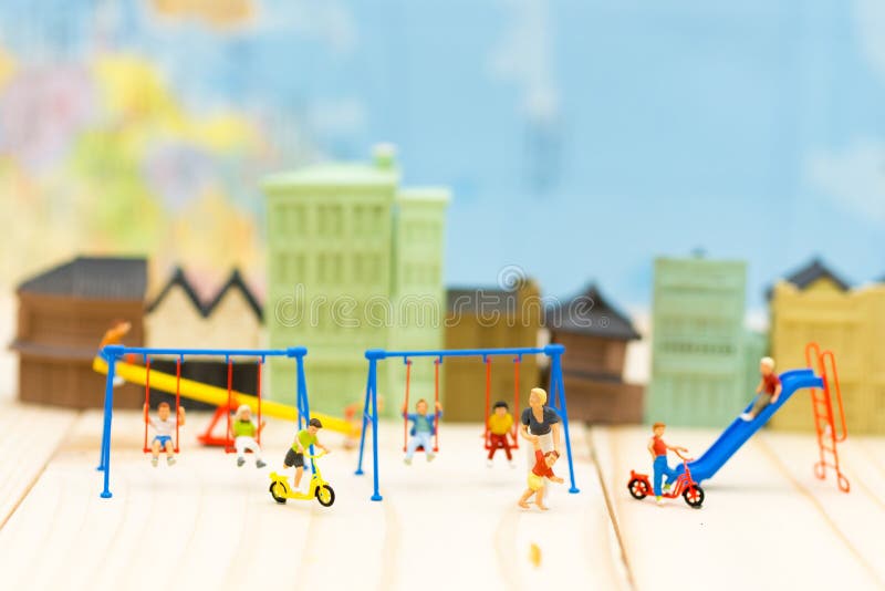 Miniature people : Mother play with son and many children at playground. Image use for background International day of families royalty free stock photos Miniature people : Mother play with son and many children at playground. Image use for background International day of families royalty free stock photos
