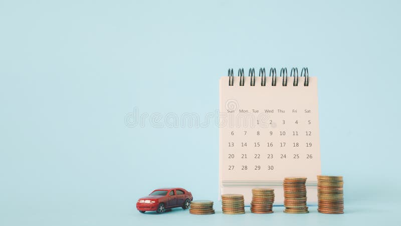 Red Car and Stack of Coins and White Calendar on Grunge Blue Background Business and Finance Red Car and Stack of Coins and White Calendar on Grunge Blue Background Business and Finance