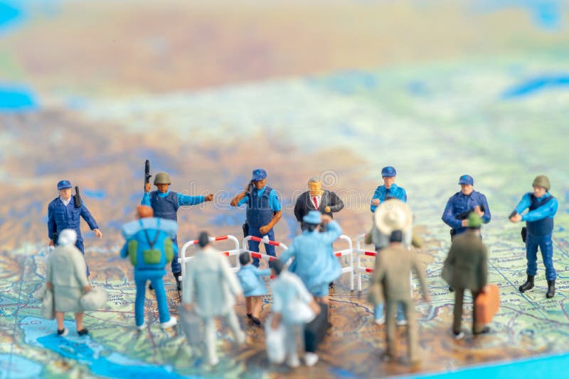 Miniature toy people concept US border patrols against a group of migrant