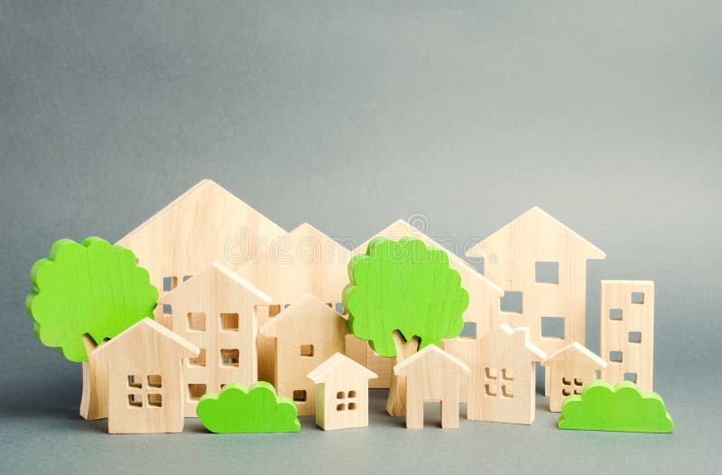 Miniature wooden toy houses and trees. Real estate concept. Architecture in the city. Infrastructure. Affordable housing.