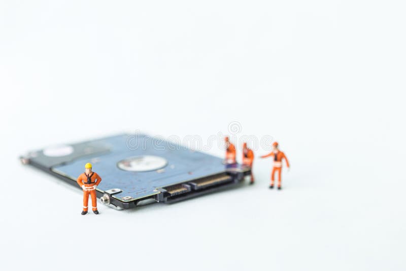 Miniature worker with hard drive disk on white background, maintenance service, technology worker, computer spare part business, safety storage
